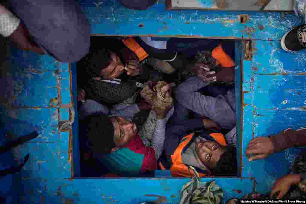 Eritreans migrants seen cramped in the hold of a large wooden boat which carried approximately 540 men women and children, mostly Eritreans. Spot News -- Third Prize, Stories (Mathieu Willcocks, MOAS)