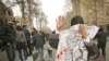 An Iranian woman masks her face with an Ashura slogan during an antigovernment demonstration in Tehran on December 27.