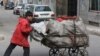 An Iranian boy pushes a cart filled with recyclable materials in south of Tehran on March 12, 2008. Iranian political factions made a final effort today to win votes on the last full day of a brief and muted campaign for an election expected to consolidat