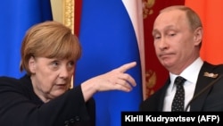 Lost in translation? German Chancellor Angela Merkel (left) gestures as Russian President Vladimir Putin looks on during the pair's joint press conference at the Kremlin in Moscow on May 10. 