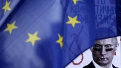 A poster depicting Russian President Vladimir Putin is seen behind an EU flag during a rally by the Czech Republic's Ukrainian community following Russia's invasion of Crimea, in Prague in 2014.