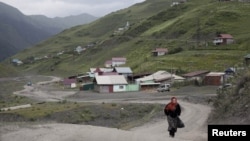 A woman on a road in the settlement of Akhty in southern Daghestan.