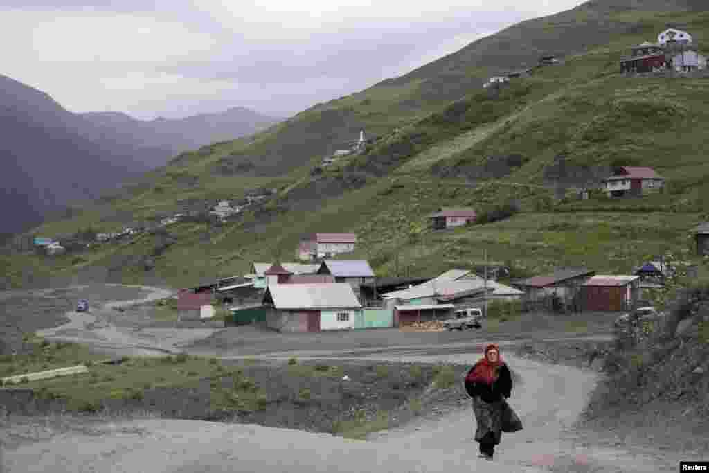 A woman walks along a road in the settlement of Akhty in southern Daghestan.
