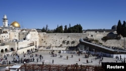The Western Wall (center), the Dome of the Rock (left), and the Al-Asqa mosque (right) in Jerusalem's Old City