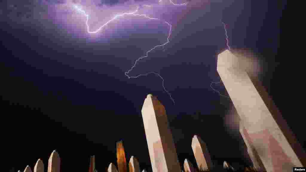 Lightning strikes near the Memorial Center in Potocari on July 10, the night before a mass burial. The bodies of 520 recently identified victims of the 1995 Srebrenica massacre were buried on July 11, the anniversary of the killing of some 8,000 Muslims by Bosnian Serb forces. (Reuters/Dado Ruvic)