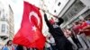 A masked demonstrator waves a Turkish flag during a protest in central Istanbul in late May.