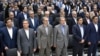 The US slapped sanctions on Iranian businessman Ali Ansari (second from left), shown in undated photo.