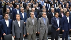 The US slapped sanctions on Iranian businessman Ali Ansari (second from left), shown in undated photo.