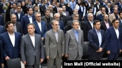 The US slapped sanctions on Iranian businessman Ali Ansari (second from left), shown in undated photo.