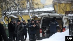 Russian police officers and investigators crowd at the site of the killing of Aslan Usoyan, better known as "Ded Khasan" (Grandfather Khasan), outside the Karetny Dvor restaurant in central Moscow in mid-January.