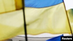 Ukraine -- Ukrainian national flags, flags of Ukrainian trade unions and EU flag are seen during a mass rally in front of the Ukrainian cabinet of ministers building in Kyiv, October 15, 2014