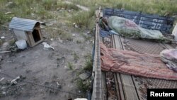 A migrant worker sleeps on top of a shelter outside Moscow.