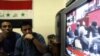 Iraqis watch the vote on television