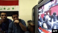 Iraqis watch the vote on television