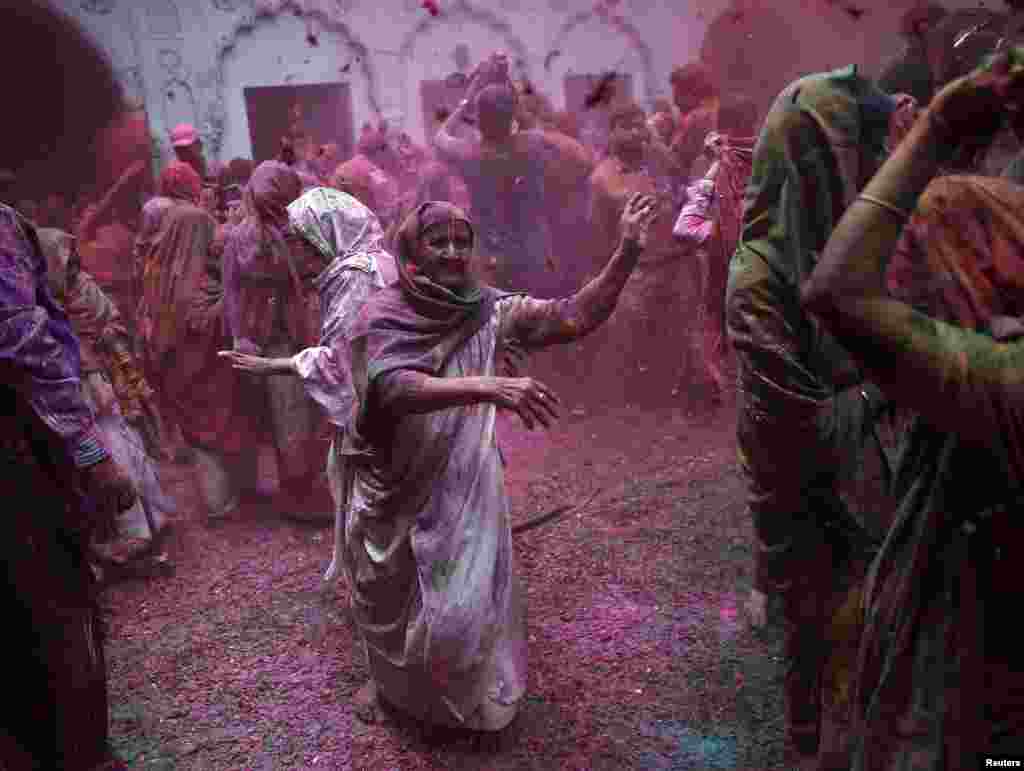 Widows daubed in colours take part in celebrations for Holi festival in Vrindavan in the northern Indian state of Uttar Pradesh on March 3. (Reuters/Ahmad Masood)