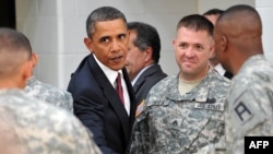 U.S. President Barack Obama shakes hands with Iraq war veterans at Fort Bliss, Texas, last year.