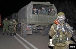 Ukrainian prisoners of war sit in a truck during their transportation to a place of exchange for pro-Russian rebels on December 26.