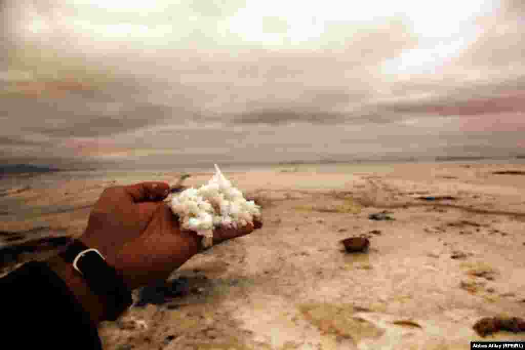 Salt drifts have accumulated in the dry lake bed.