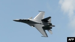 Singapore -- A Sukhoi SU-30 fighter jet from the Royal Malaysian Air Force performs a slow fly past during the Singapore Airshow at Changi exhibition center in Singapore, February 16, 2016