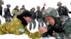 Chinese and Tajik soldiers arm wrestle during patrols near the city of Kashgar, in the northwestern autonomous region of Xinjiang, in May 2019.