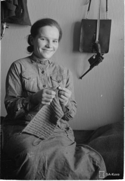 A Finnish woman with a handgun in her homestead. For Finns, the war was a crisis that unified the people and morale among fighters was relatively high.