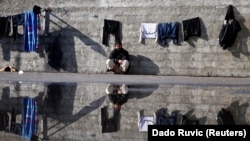 A man resting at the flooded Miral refugee camp in Velika Kladusa, Bosnia, on February 14.