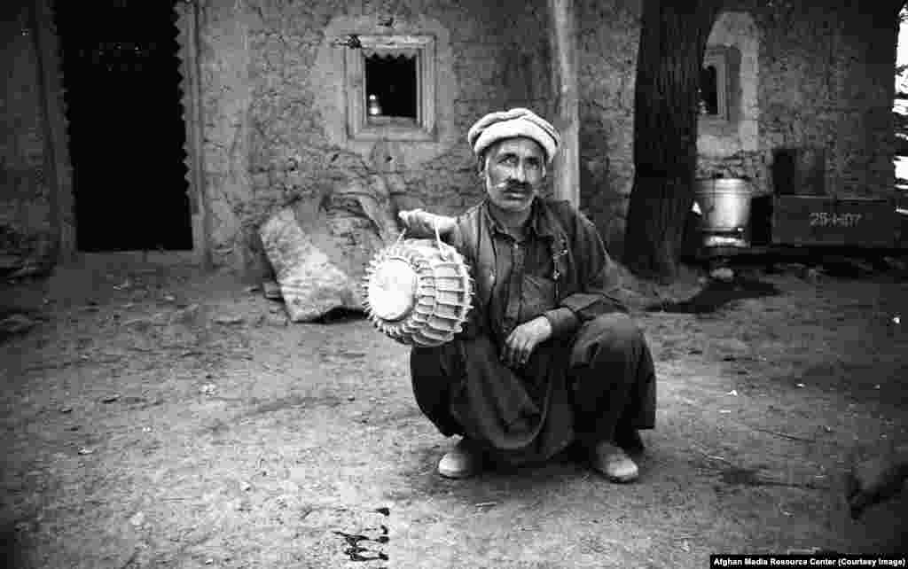 An Afghan man wielding an Italian-made antitank mine.