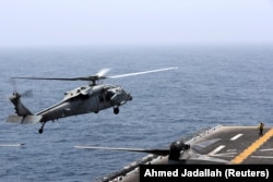 A helicopter lands on the deck of USS Boxer (file photo)