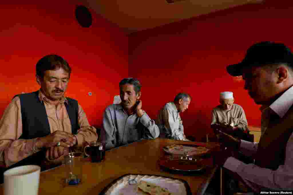 Hazara men have tea and breakfast at a local restaurant in Mariabad, Quetta, Pakistan, June 13, 2019.