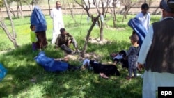 Schoolgirls in Takhar Province receive first aid after the suspected poisoning of their water supply.