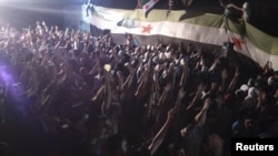 Demonstrators protest against Syria's President Bashar al-Assad at Kfr Suseh in Damascus on June 12.