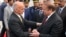 Pakistan Prime Minister Nawaz Sharif, right, greets Afghan President Ashraf Ghani upon his arrival at the military Nur Khan airbase in Rawalpindi on December 9.