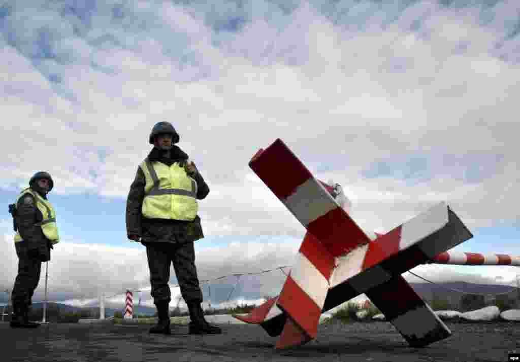 Russian peacekeepers in the Georgian region of South Ossetia in November (epa) - In May, RFE/RL spoke with Organization for Security and Cooperation in Europe chairman in office Karel De Gucht about models for resolving the so-called frozen conflicts in the former Soviet Union.