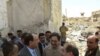 Iraqi Foreign Minister Hoshyar Zebari (second from right) speaks to Prime Minister Nuri al-Maliki (second from left) as he surveys the damage following a truck bomb placed outside the Foreign Ministry building in Baghdad on August 24.