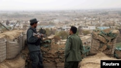 Afghan police officers keep watch at their forward base in Kunduz (file photo).