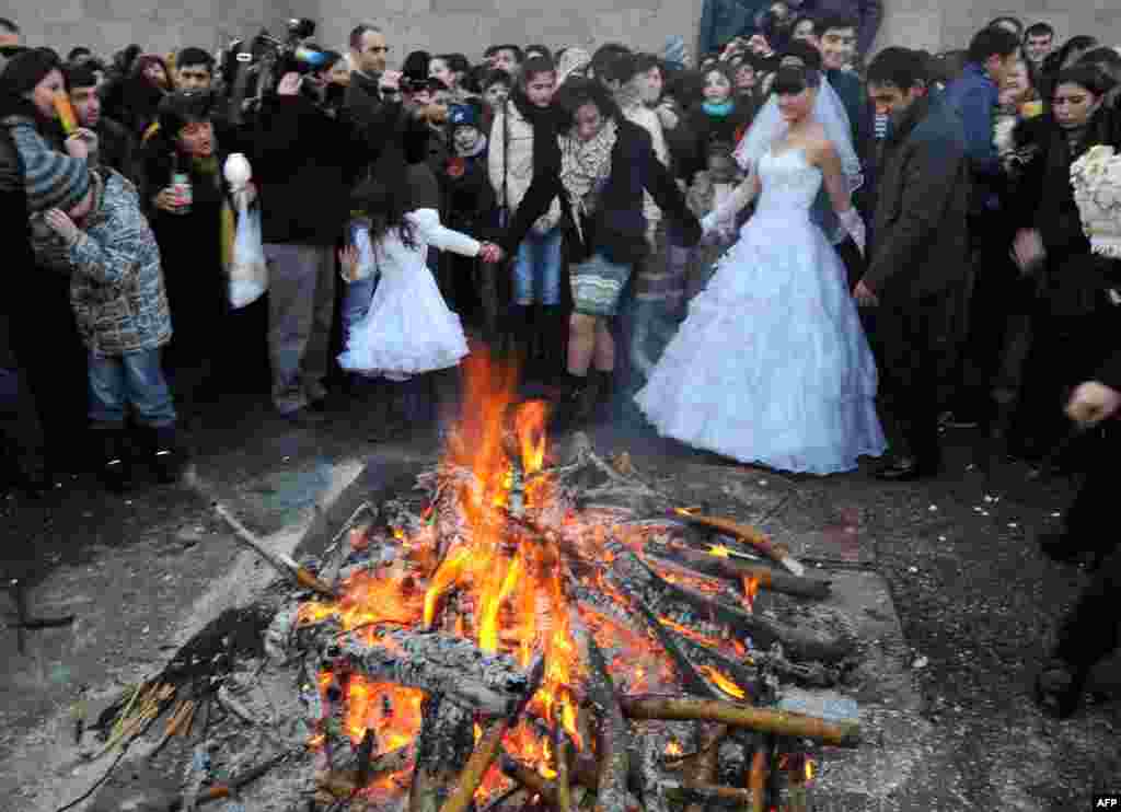 A wedding party crowds around a bonfire to mark Trndez, an ancient pagan festival now absorbed into the Christian calendar, in Yerevan, Armenia.3. (AFP/Karen Minasyan)