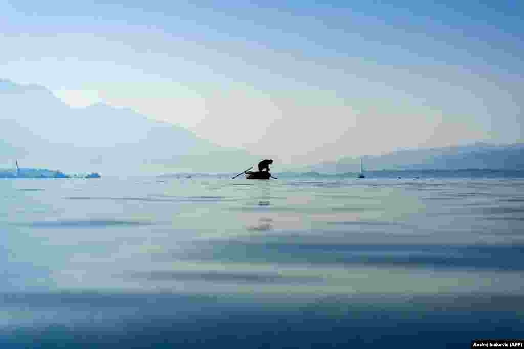 A fisherman checks his catch in the Bay of Kotor near the coastal town of Bijela, Slovenia. (AFP/Andrej Isakovic)