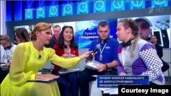 A question about Russian opposition leader and Kremlin foe flashes on the screen: "Why wasn't Aleksei Navalny allowed to register as a presidential candidate?"