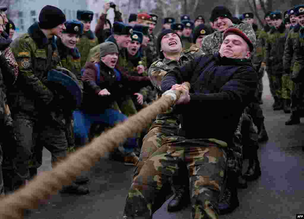 Belarusian interior special forces take part in a tug of war as they celebrate Maslenitsa (Shrovetide), a farewell ceremony to winter in Minsk on February 19. (AFP/Maxim Malinovsky)