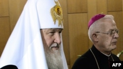 Russian Orthodox Patriarch Kirill (left) walks with the head of the Polish Roman Catholic Church, Archbishop Jozef Michalik, prior to their meeting in Warsaw on August 16.