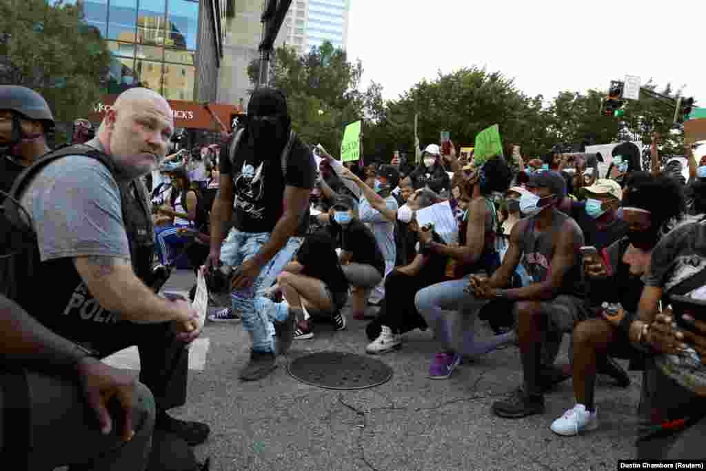 Офіцери поліції опустилися на одне коліно на знак солідарності із учасниками акції протесту, які у мирний спосіб вимагають справедливості щодо факту загибелі в Міннеаполісі Джорджа Флойда. Атланта, штат Джорджія. 1 червня 2020 року (Фото REUTERS/Dustin Chambers)