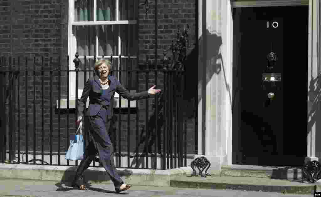 Then-British Home Secretary Theresa May turned the wrong way after leaving No. 10 Downing Street and had to backtrack after attending the last cabinet meeting hosted by former British Prime Minister David Cameron in London on July 12. May became prime minister herself on July 13 after Cameron resigned. (epa/Will Oliver)