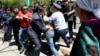 Kazakhstan -- Riot police officers detain demonstrators during a protest against President's government and the land reform it has proposed, in Almaty, May 21, 2016