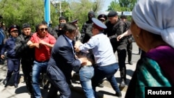 Kazakh riot police in Almaty detain demonstrators during a protest against proposed land reforms, in May 2016.
