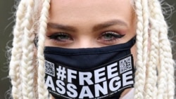 Nina iz Amsterdama, pristalica osnivača WikiLeaksa, Julian Assange, nosi zaštitnu masku za lice sa natpisom koji poziva na Assangeovu slobodu, ispred Woolwich Crown Court na jugoistoku Londona, 24. februar 2020.