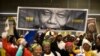 People arrive at the First National Bank (FNB) Stadium, also known as Soccer City, ahead of the national memorial service for late President Nelson Mandela in Johannesburg.