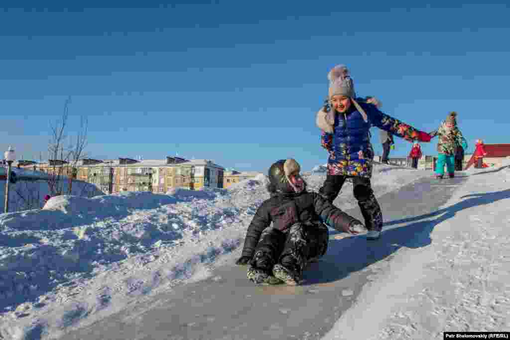Local children slide down a snowhill in a central square in Vorkuta.&nbsp;