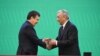 Uzbek President-elect Shavkat Mirziyaev, left, is sworn in at a joint session of the parliament in Tashkent on December 14.