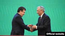 Uzbek President-elect Shavkat Mirziyaev, left, is sworn in at a joint session of the parliament in Tashkent on December 14.