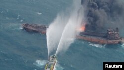 A rescue ship works to extinguish the fire on the stricken Iranian oil tanker Sanchi in the East China Sea, on January 10, 2018 in this photo provided by Japan’s 10th Regional Coast Guard.
